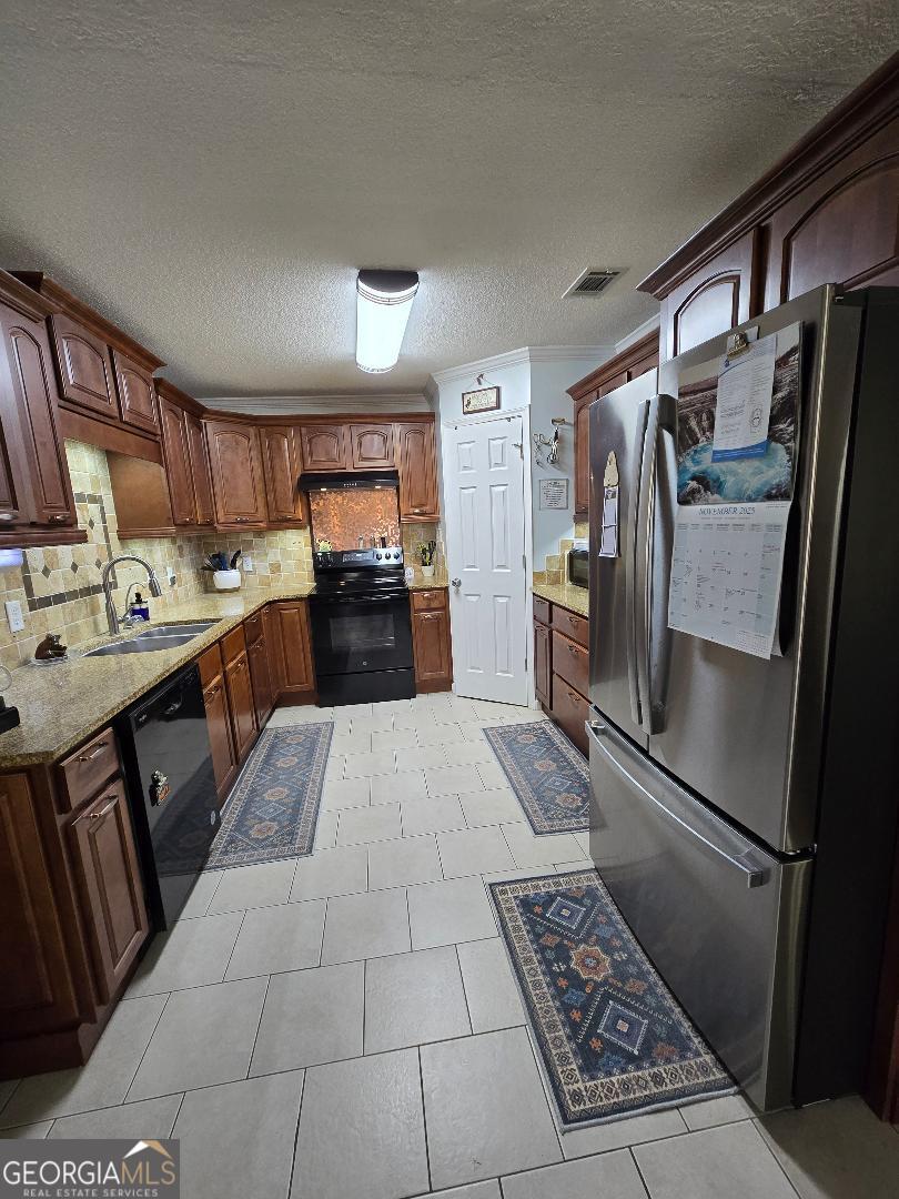 5002 Addison Trail Statesboro, GA 30458 - Photo 7 of 35 a kitchen with stainless steel appliances granite countertop a refrigerator stove and sink
