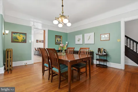 a view of a dining room with furniture wooden floor and chandelier