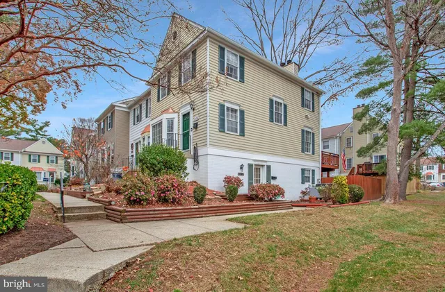 a view of a white house with a yard and a fire pit