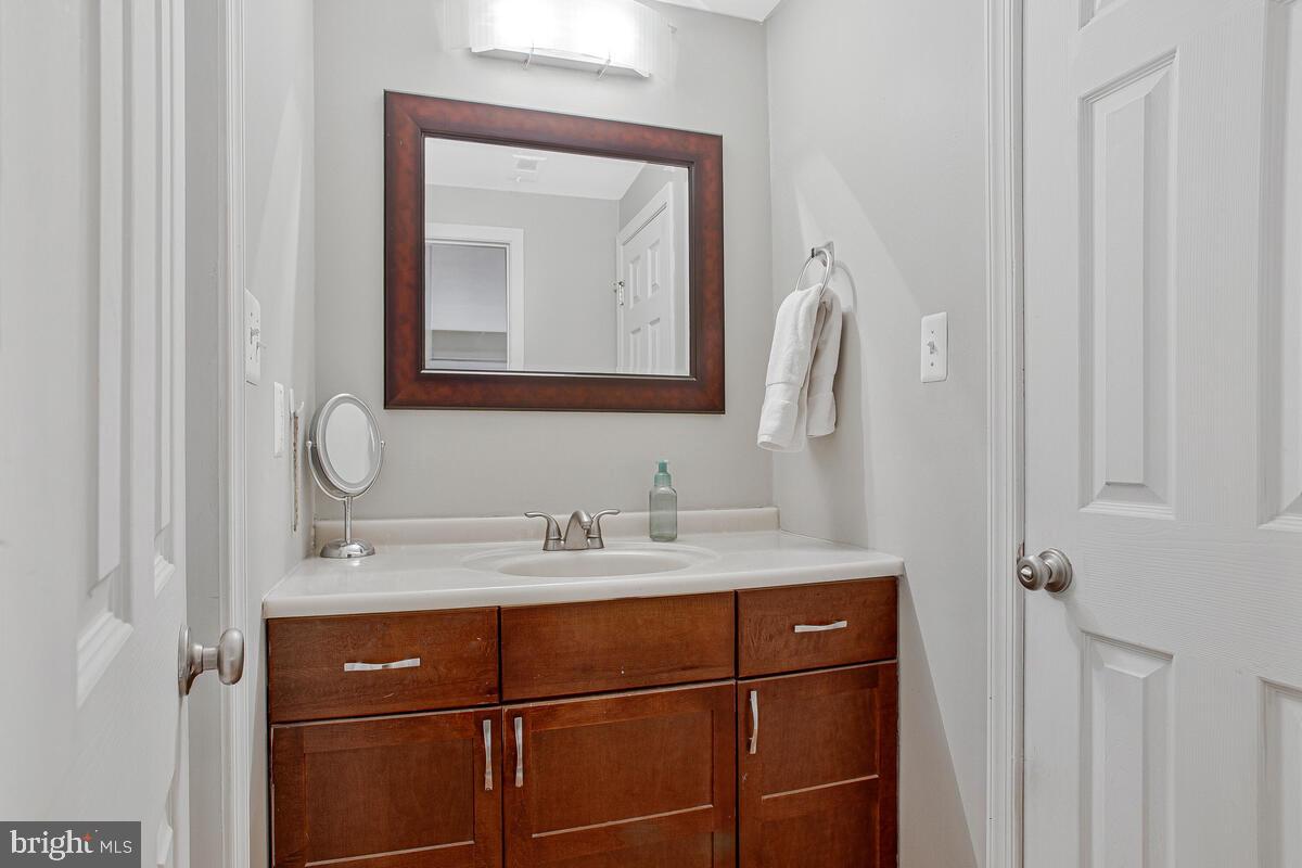 1438 Orleans Court Crofton, MD 21114 - Photo 11 of 26 a bathroom with a sink vanity and a mirror