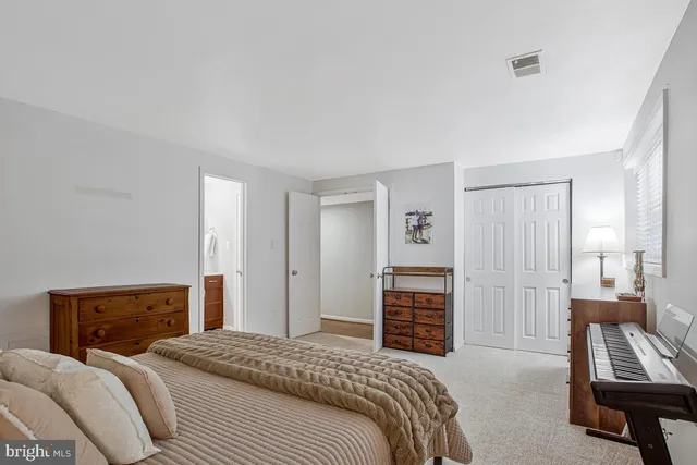a bedroom with a bed and dresser