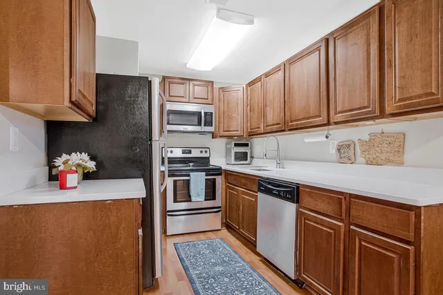 a kitchen with stainless steel appliances granite countertop a refrigerator sink and cabinets