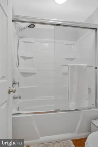 a bathroom with a shower and a bath tub