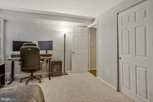 a view of a workspace with furniture and a workspace