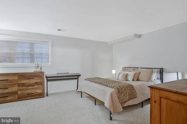 a bed room with a bed and dresser