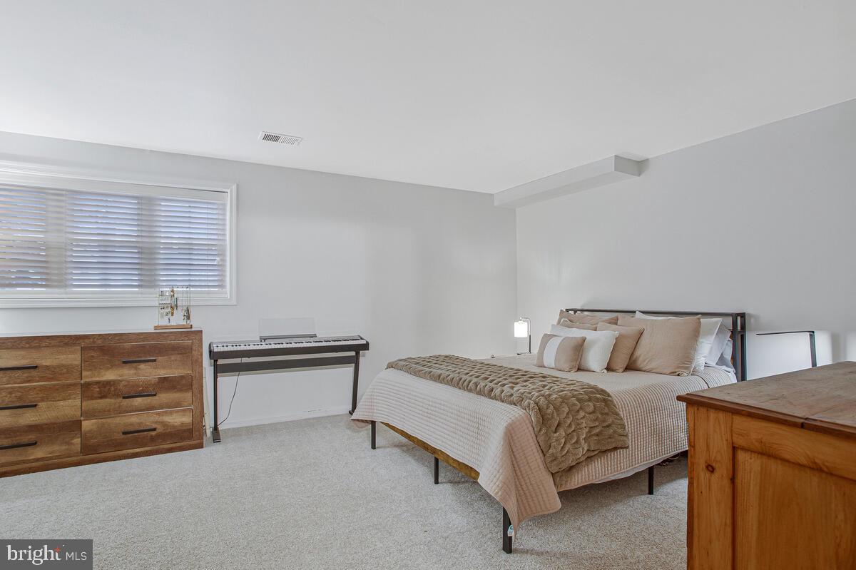 1438 Orleans Court Crofton, MD 21114 - Photo 17 of 26 a bed room with a bed and dresser