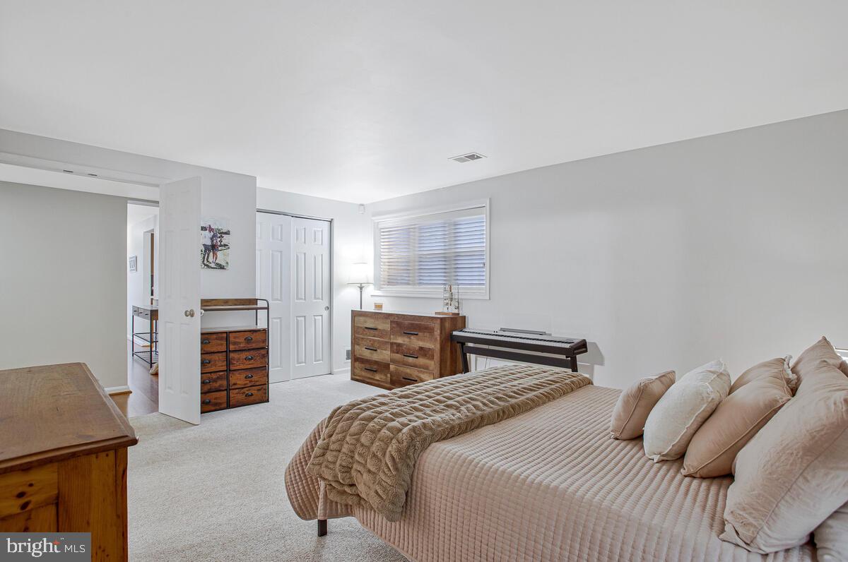 1438 Orleans Court Crofton, MD 21114 - Photo 19 of 26 a bedroom with a bed and dresser