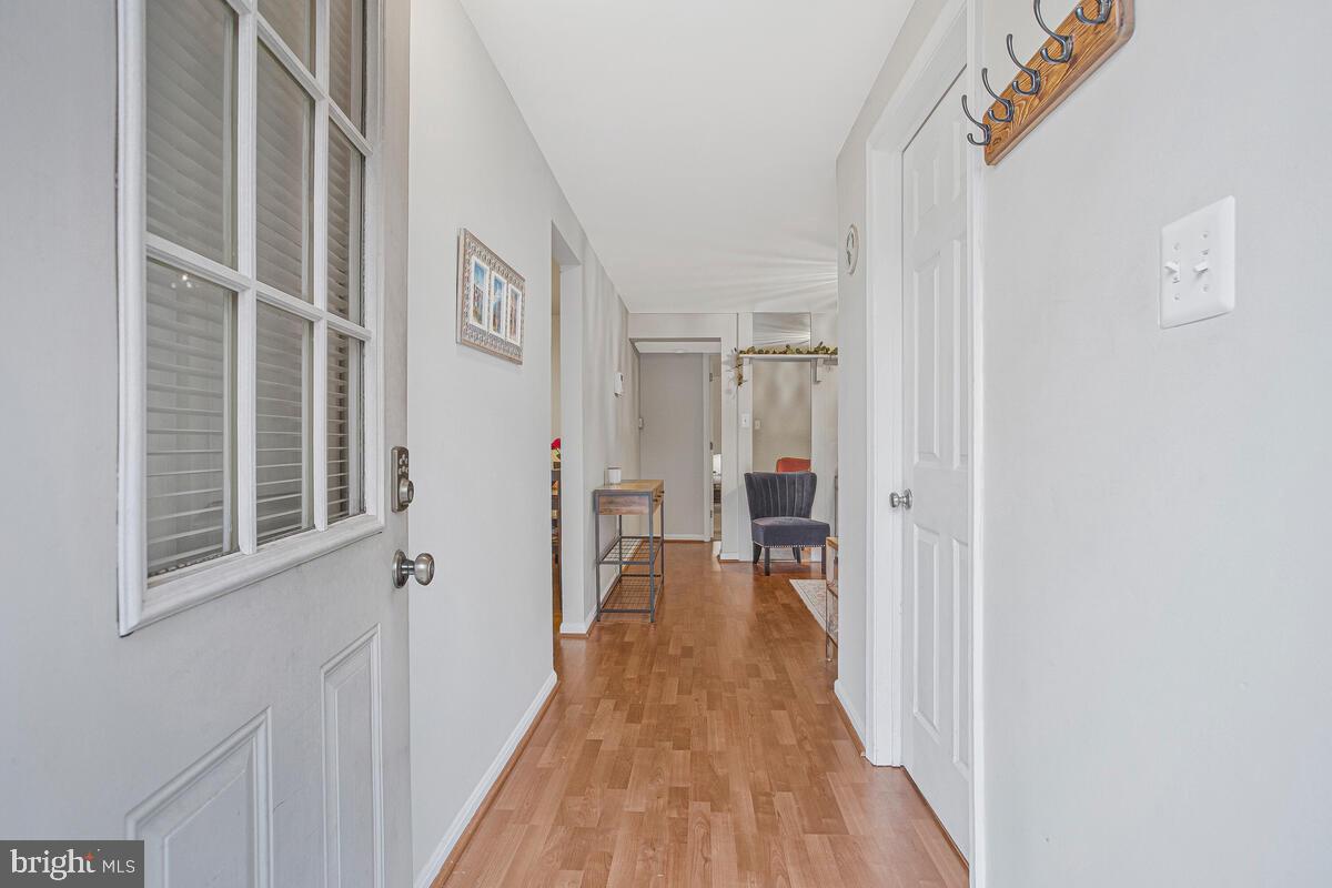 1438 Orleans Court Crofton, MD 21114 - Photo 22 of 26 a view of a hallway with wooden floor and closet
