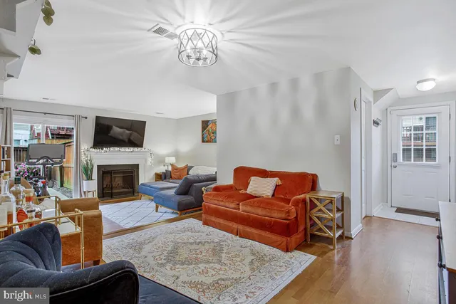 a living room with furniture a fireplace and a flat screen tv