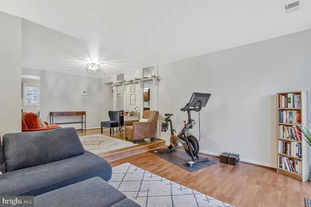 a view of a livingroom with workspace and a window