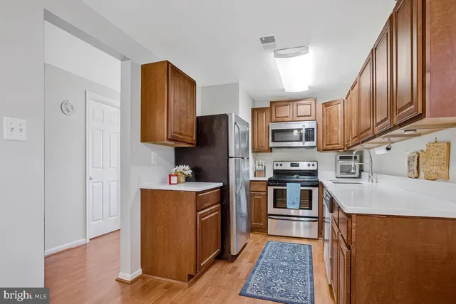 a kitchen with stainless steel appliances granite countertop a refrigerator stove and oven