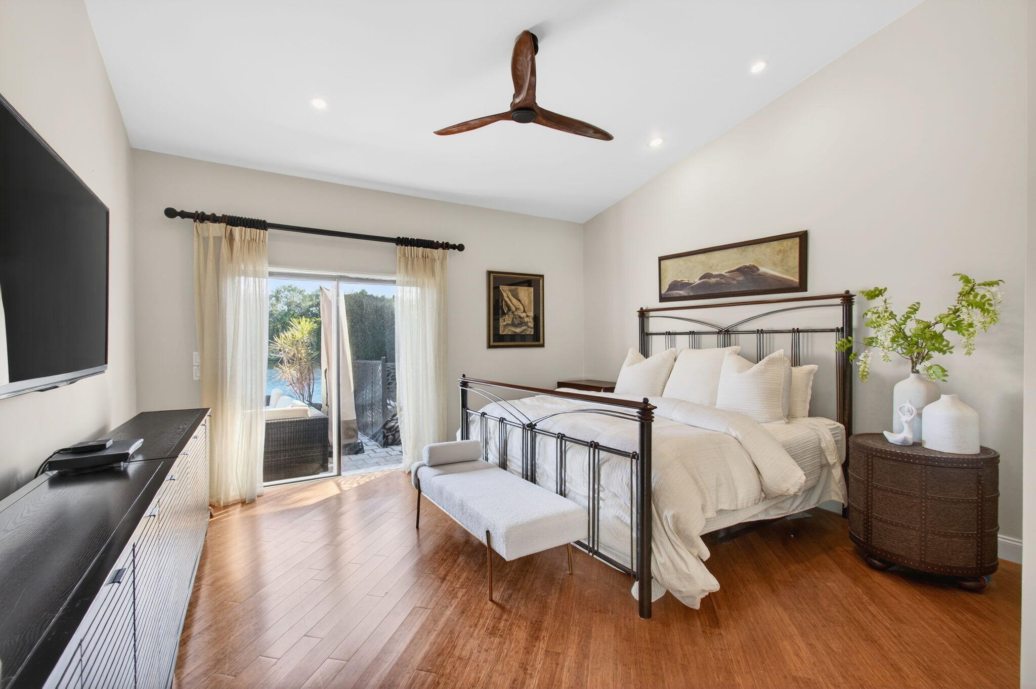23145 Via Stel Boca Raton, FL 33433 - Photo 25 of 72 a bedroom with a bed and a flat tv screen on the dresser