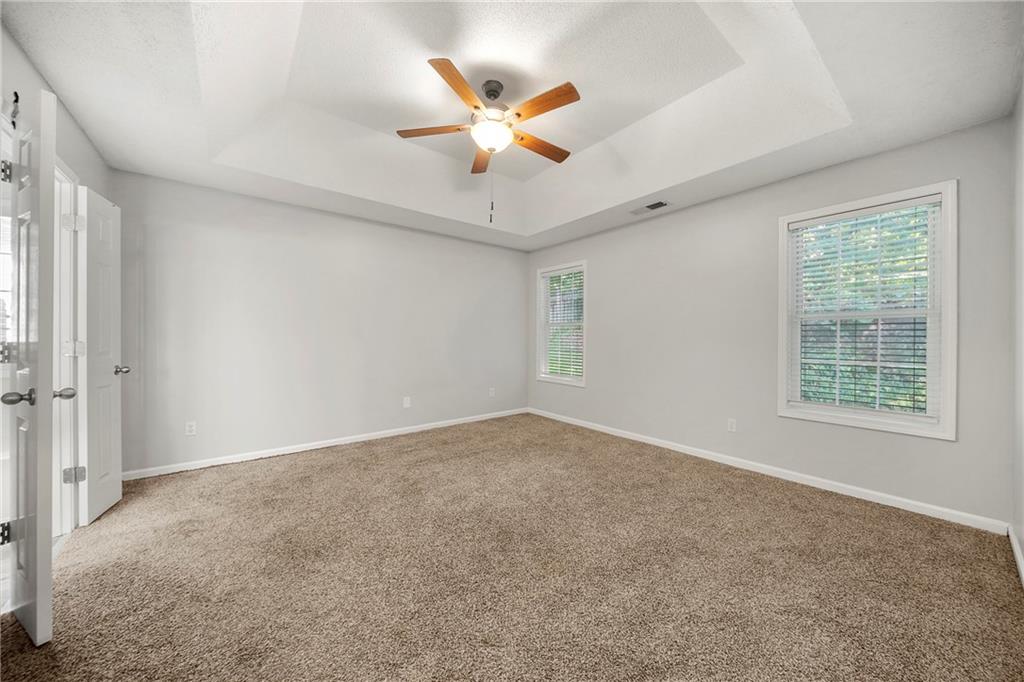 4317 Chesapeake Trace Acworth, GA 30101 - Photo 11 of 22 a view of an empty room with a ceiling fan and window