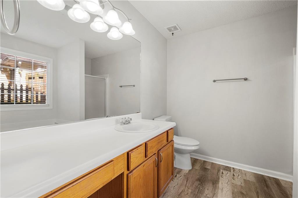 4317 Chesapeake Trace Acworth, GA 30101 - Photo 13 of 22 a bathroom with a sink a toilet and a mirror