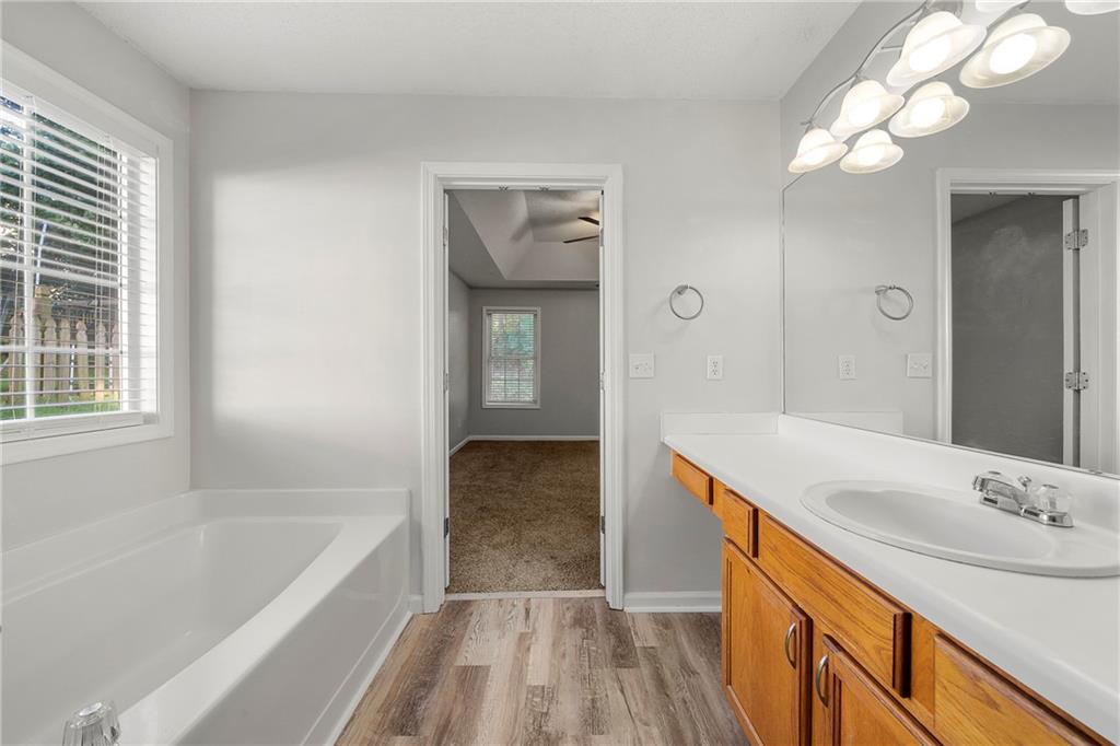 4317 Chesapeake Trace Acworth, GA 30101 - Photo 14 of 22 a bathroom with a tub sink and mirror
