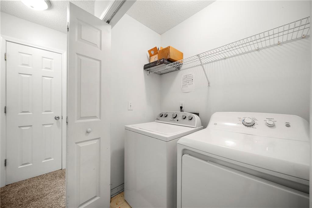 4317 Chesapeake Trace Acworth, GA 30101 - Photo 16 of 22 a view of storage and utility room with washer and dryer