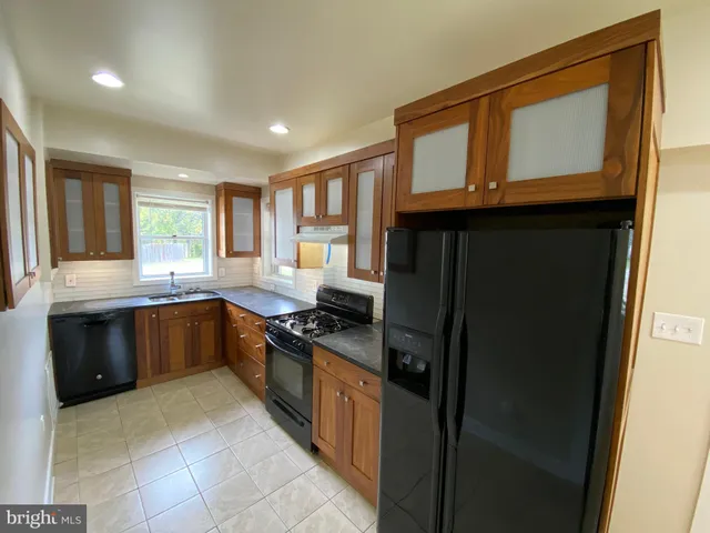 a kitchen with a refrigerator and a sink