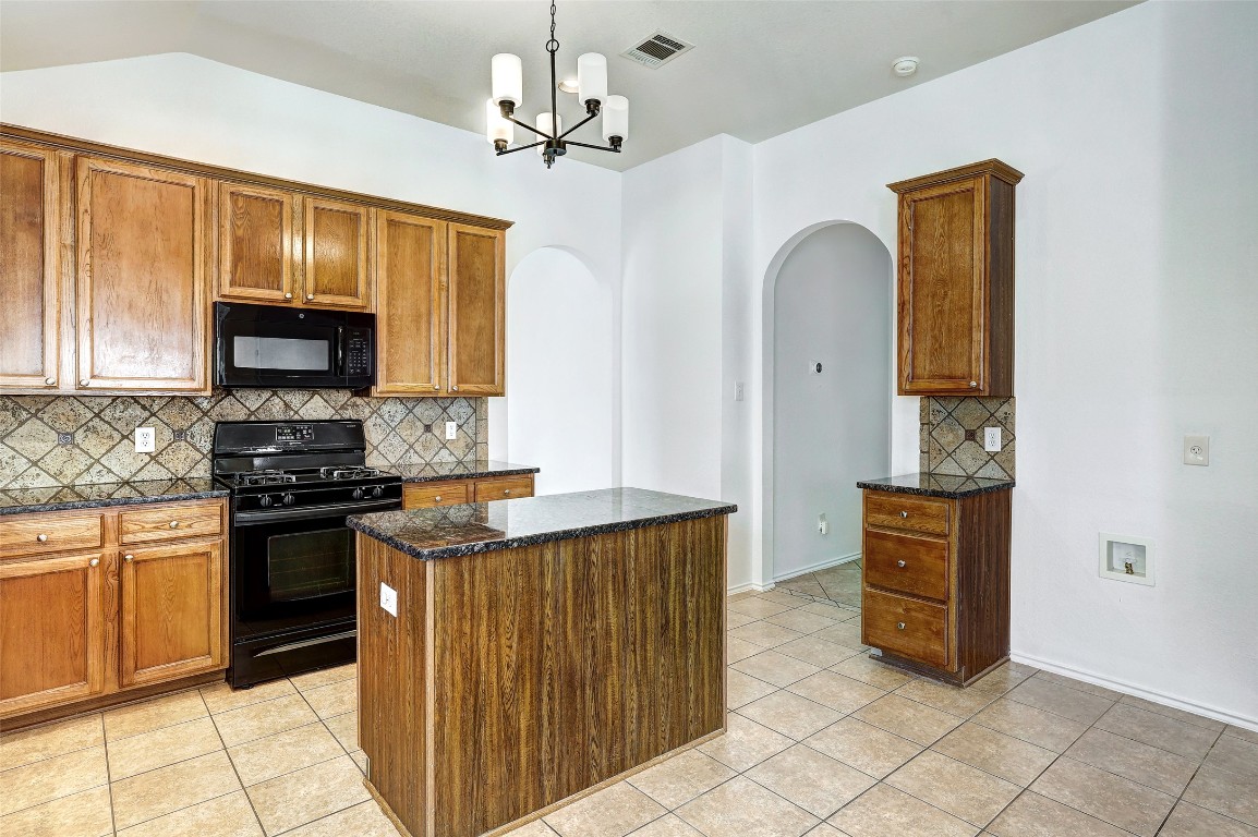 1517 Rainbow Parke Drive Round Rock, TX 78665 - Photo 13 of 38 a kitchen with stainless steel appliances granite countertop a stove top oven a sink and dishwasher