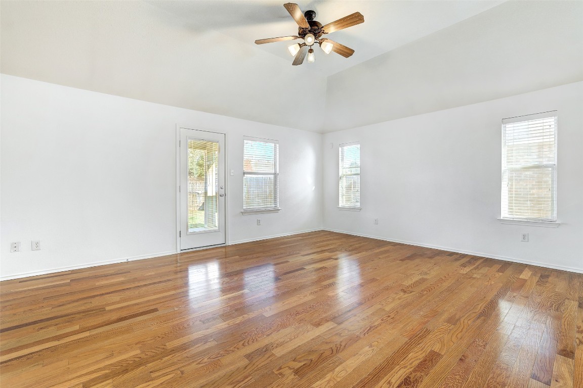 1517 Rainbow Parke Drive Round Rock, TX 78665 - Photo 16 of 38 an empty room with wooden floor fan and windows