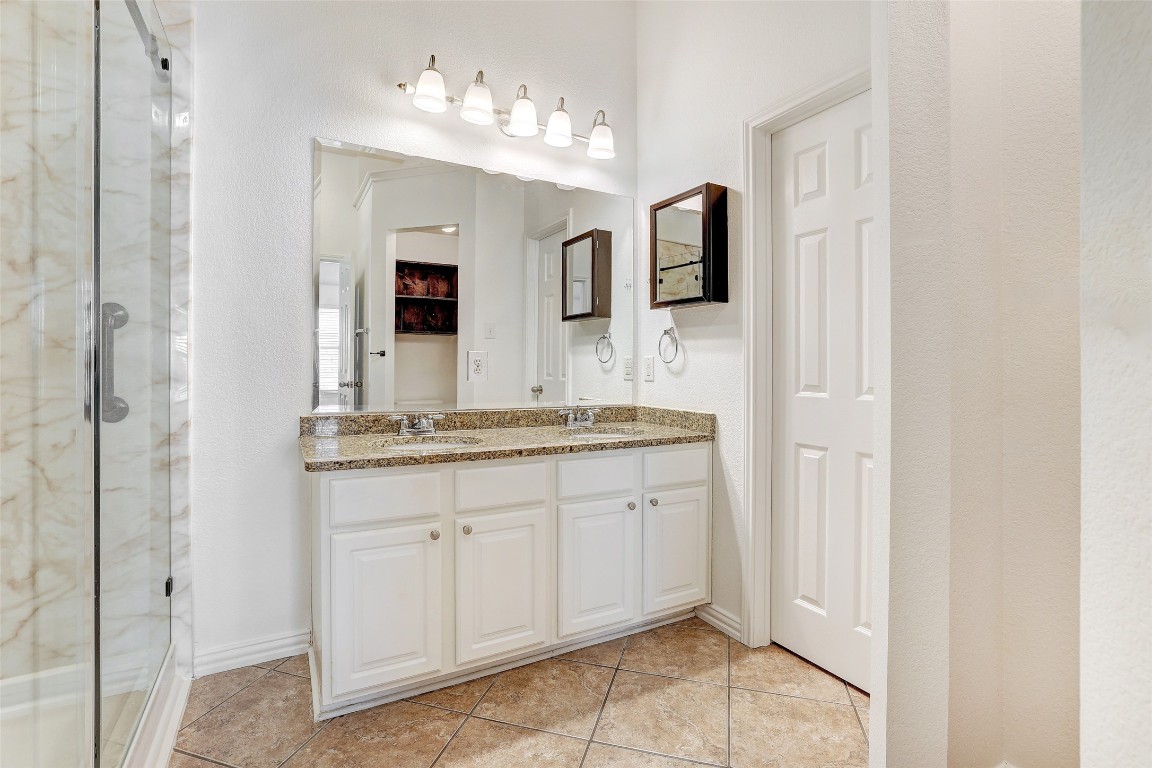 1517 Rainbow Parke Drive Round Rock, TX 78665 - Photo 24 of 38 a spacious bathroom with a granite countertop sink and a mirror