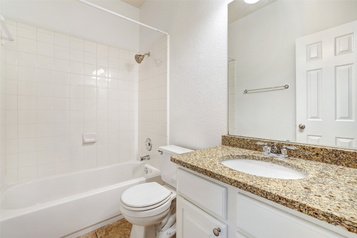 1517 Rainbow Parke Drive Round Rock, TX 78665 - Photo 33 of 38 a bathroom with a granite countertop sink toilet and shower