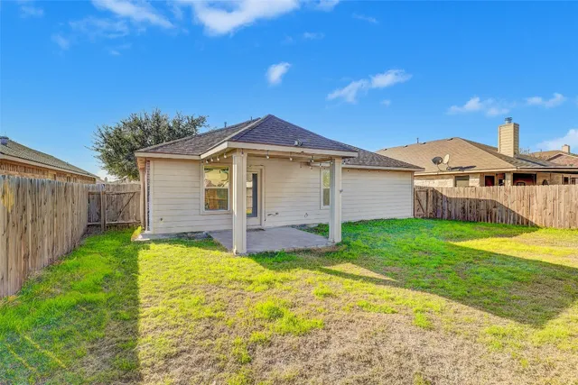 a view of an house with backyard and porch