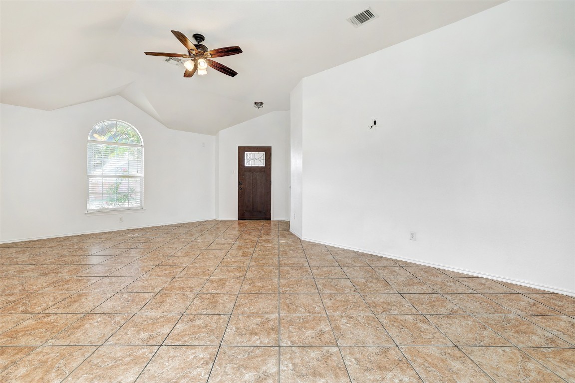 1517 Rainbow Parke Drive Round Rock, TX 78665 - Photo 8 of 38 an empty room with windows and ceiling fan