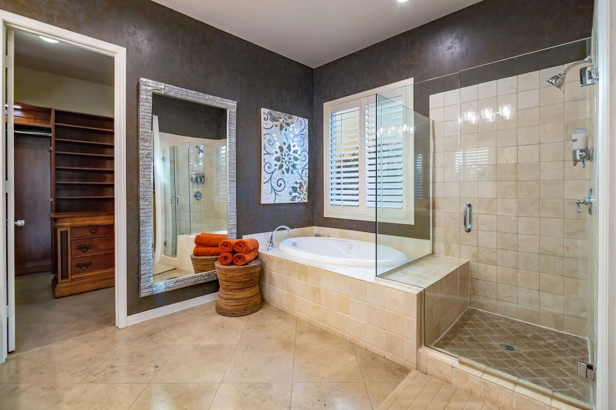 43875 Spiaggia Place Indio, CA 92203 - Photo 32 of 52 a spacious bathroom with a tub a potted plant and a shower