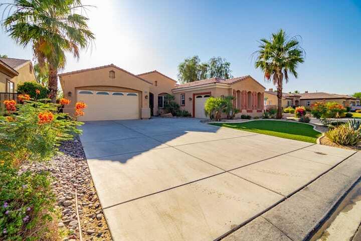 43875 Spiaggia Place Indio, CA 92203 - Photo 46 of 52 a front view of a house with a garden and trees