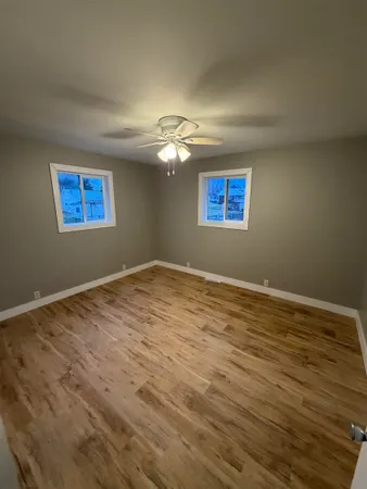 a view of an empty room with wooden floor