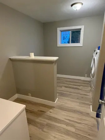 a view of a room with wooden floor and sink
