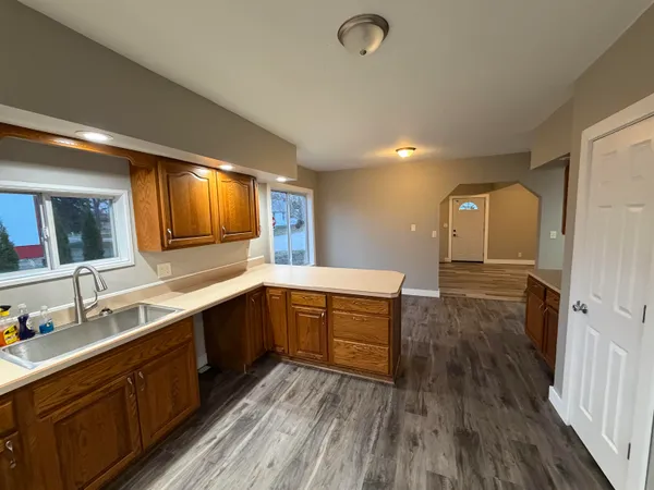 a living room with furniture flat screen tv and window