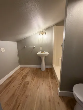 a view of a house with a yard and wooden deck