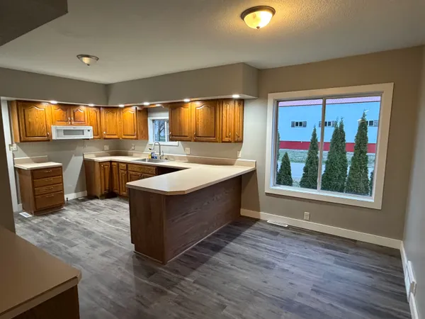 a kitchen with sink cabinets and wooden floor