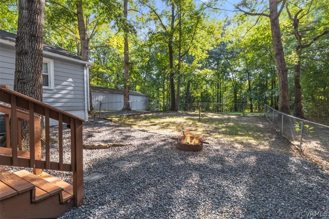 4101 Courthouse Road Chesterfield, VA 23236 - Photo 26 of 30 a view of a backyard with large trees and wooden fence