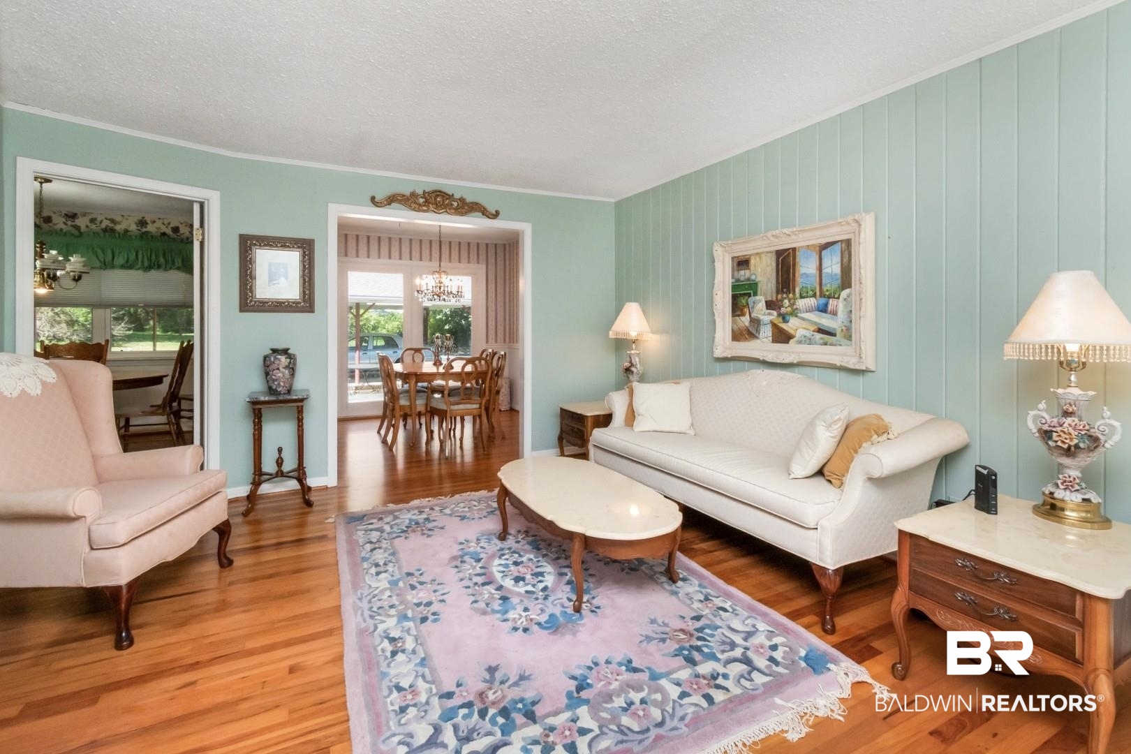 6300 Woodcrest Drive Mobile, AL 36608 - Photo 4 of 35 Living area with wood finished floors, crown molding, and a healthy amount of sunlight