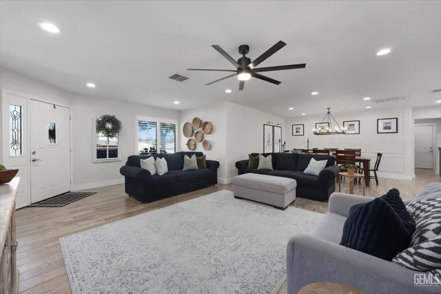 a kitchen with stainless steel appliances granite countertop a kitchen island a stove and a sink