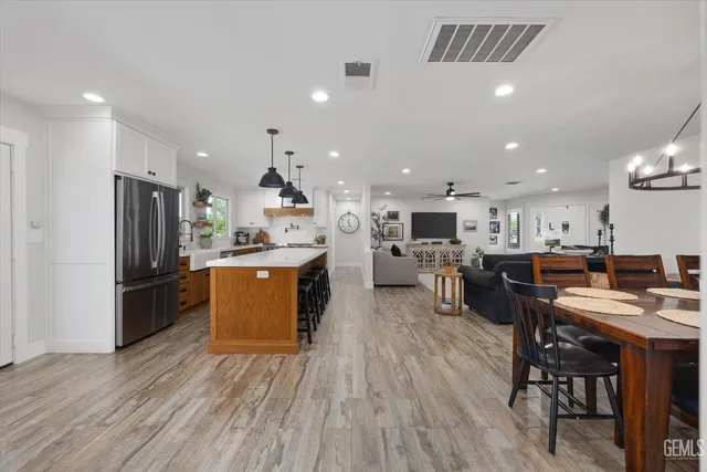 a kitchen with stainless steel appliances a stove a window and a cabinets