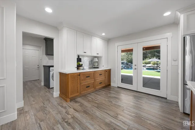a kitchen with granite countertop a sink stove and cabinets