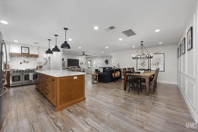 a spacious bedroom with a bed and a chandelier
