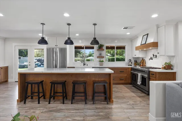 a bedroom with a bed dresser and a flat tv screen