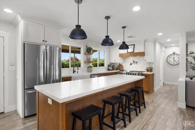 a spacious bathroom with a double vanity sink toilet and a mirror
