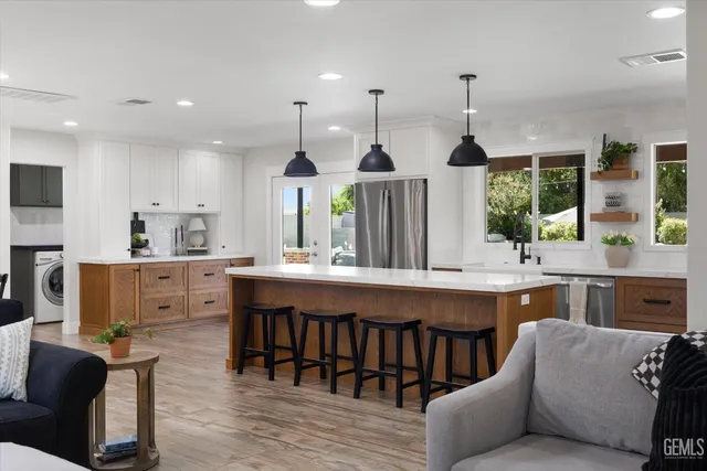 a bathroom with a granite countertop sink toilet a mirror and a window