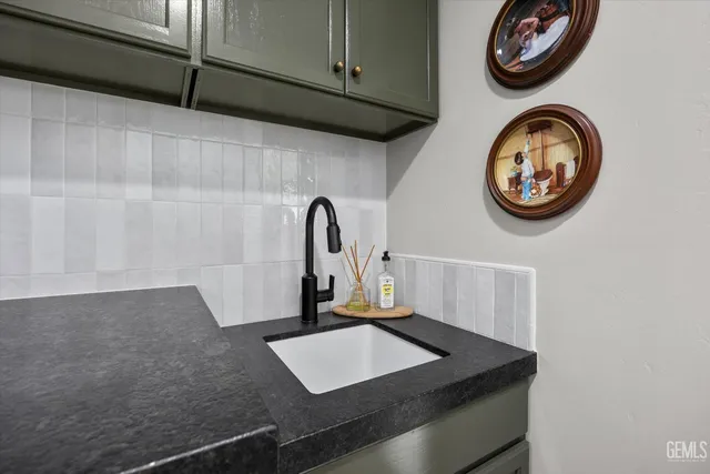 a utility room with sink dryer and washer