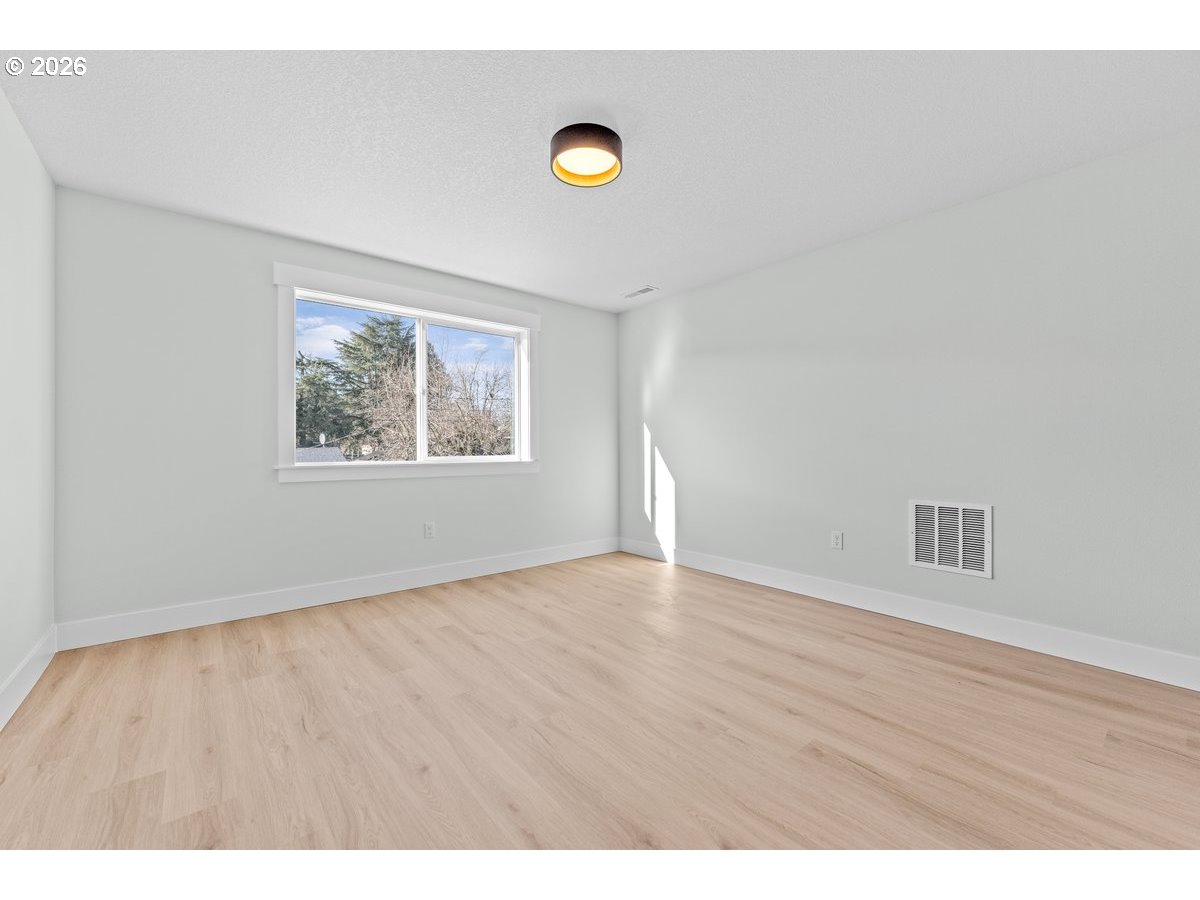 407 South 1st Street Silverton, OR 97381 - Photo 12 of 13 a view of an empty room with wooden floor and a window