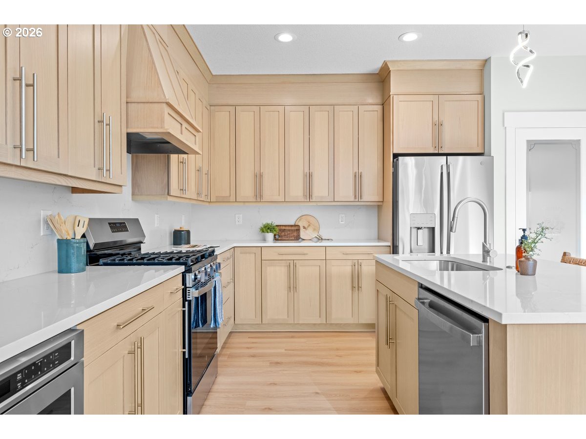 407 South 1st Street Silverton, OR 97381 - Photo 5 of 13 a kitchen with stainless steel appliances granite countertop a sink stove and cabinets