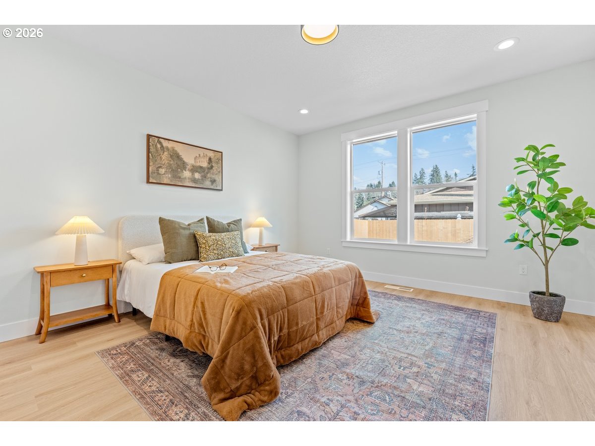 407 South 1st Street Silverton, OR 97381 - Photo 8 of 13 a spacious bedroom with a bed and a window