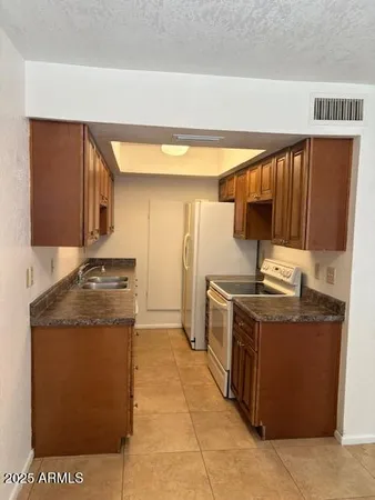 a kitchen with stainless steel appliances granite countertop a stove and a sink