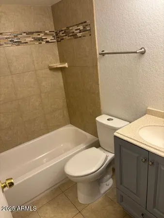 a white toilet sitting next to a bath tub and a shower