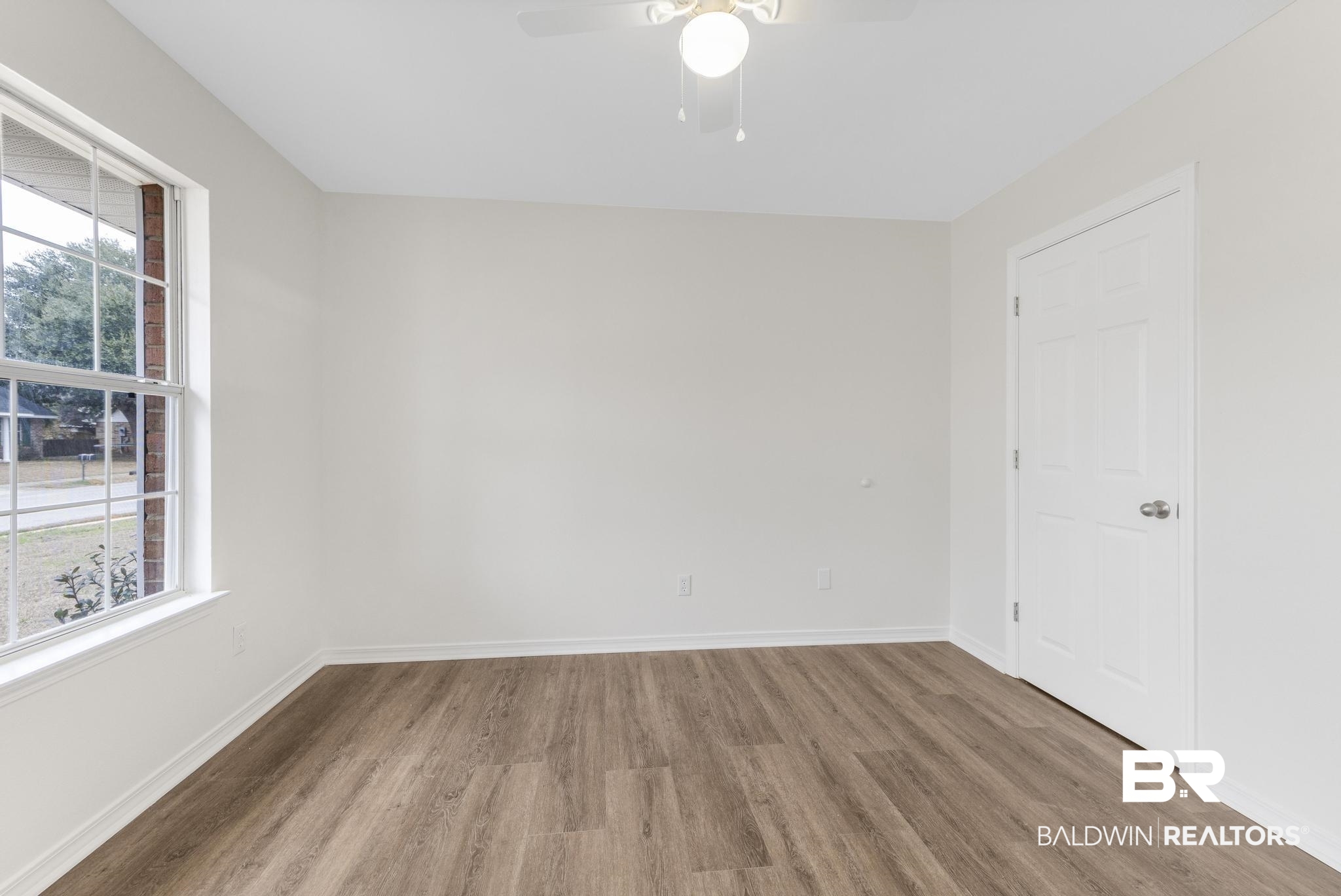16330 Absalom Street Foley, AL 36535 - Photo 27 of 42 Unfurnished room with ceiling fan, plenty of natural light, and wood-type flooring